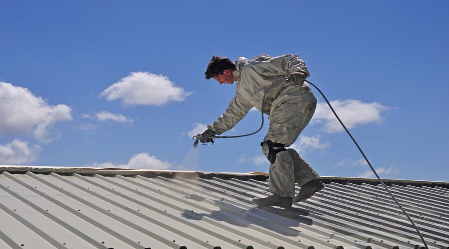 Professional technician applying advanced coating system with specialized equipment